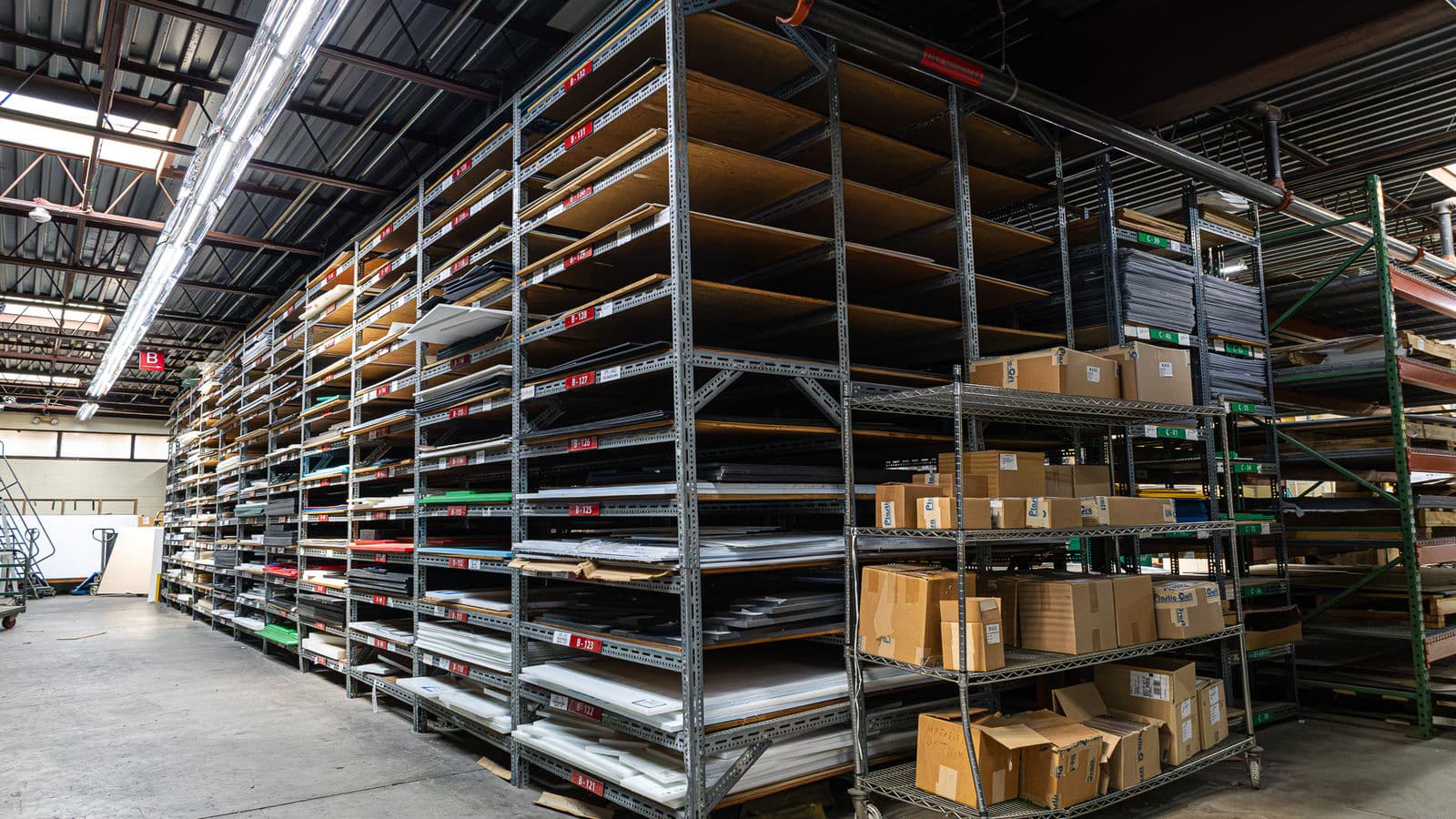 Material inventory stored on warehouse shelving at Plastic-Craft Products