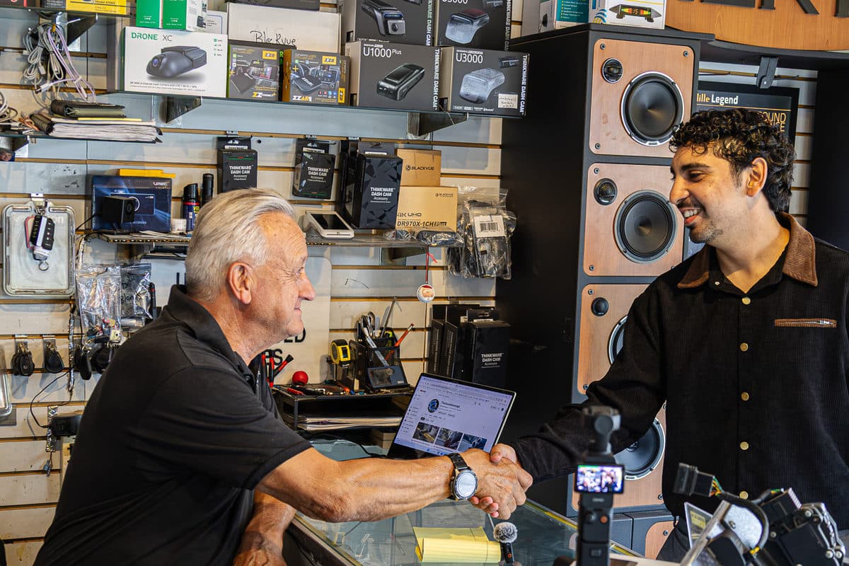Ali shaking hands with the owner of Sound Concept at their Nanuet shop